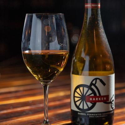 A bottle and glass of white wine.