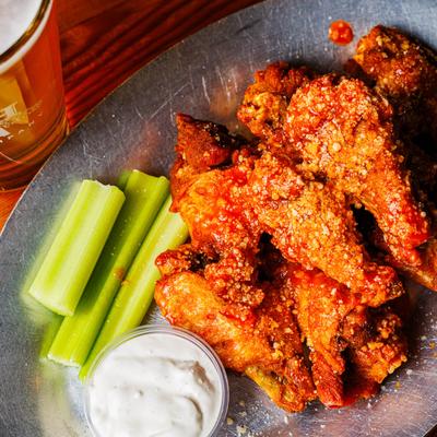 Bone in wings with dipping sauce and celery.