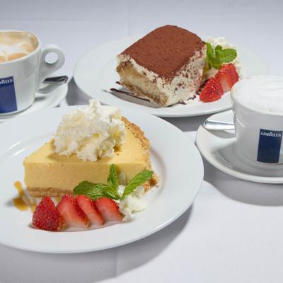 Couple of desserts served with two cups of coffee.
