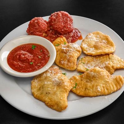 Fried ravioli served with meatballs and marinara.