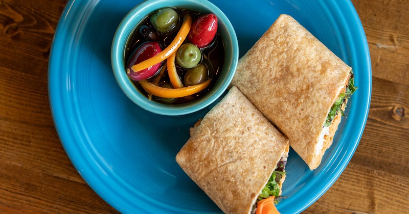 A served turkey and hummus wrap