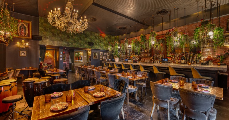 Wide view to diner and bar area, music spot, congas, tables, chairs, chandeliers