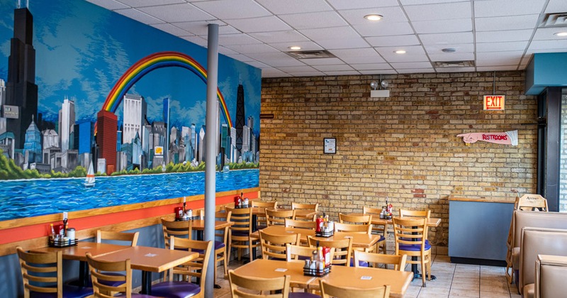 Tables and chairs, big city landscape mural on the wall