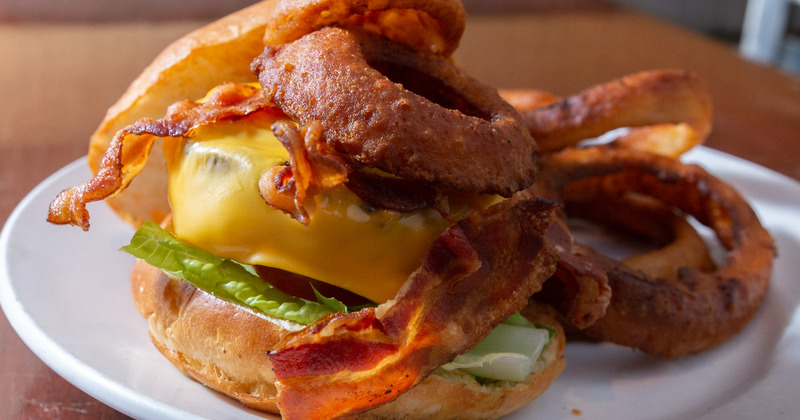 Cheesburger served with bacon and onion rings