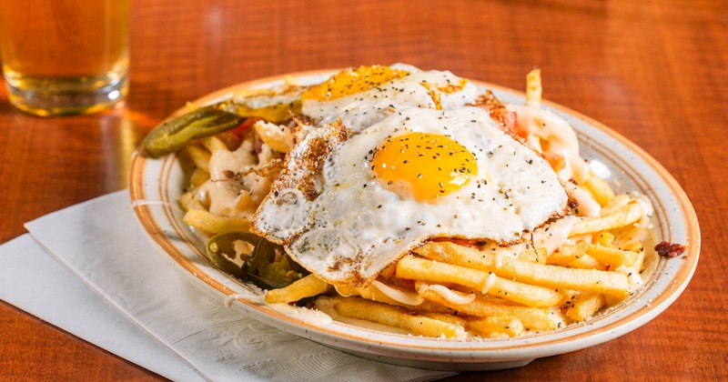 Fries with fried egg on top