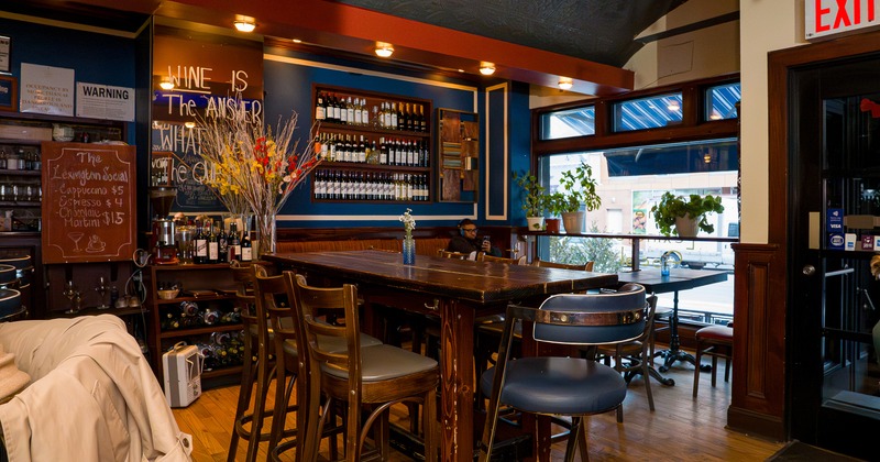 Cozy and casual interior space, wooden high table with stools
