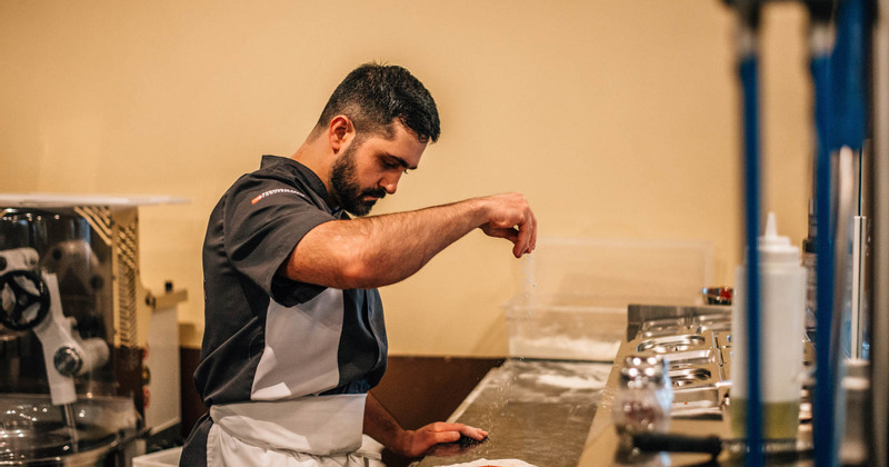 A pizza maker in action