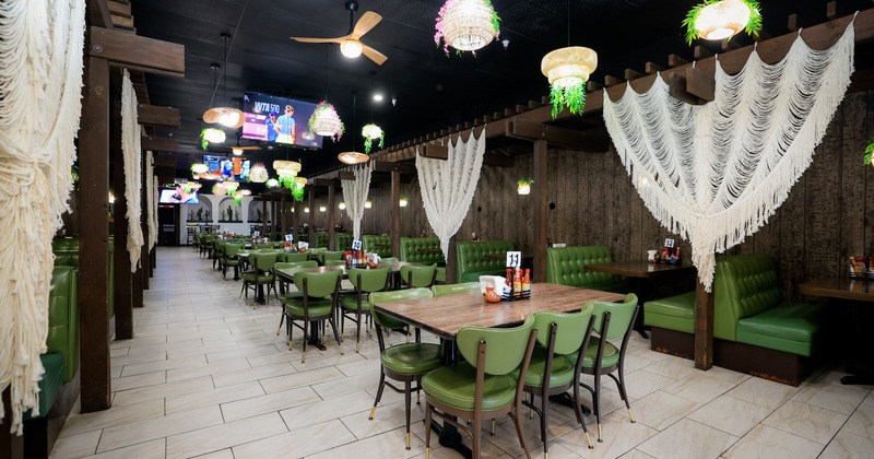 Interior, dining area with chandeliers, curtains and TV screens