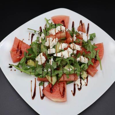 Salad with arugula, watermelon, cucumber, feta, and balsamic.