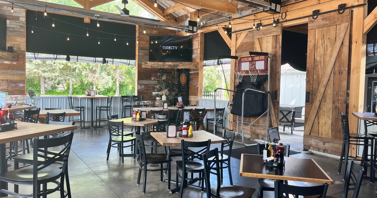 Seating area under a large wooden structure with barn-style sliding doors