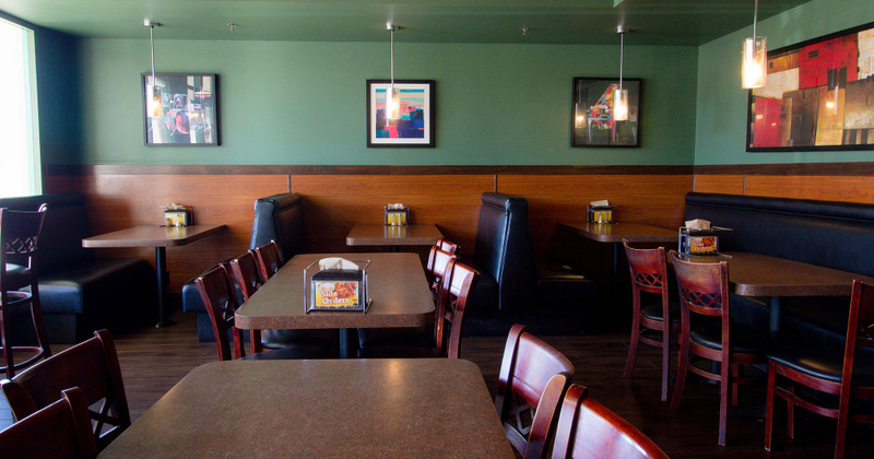 Interior, dining tables and booths, walls decorated with artwork