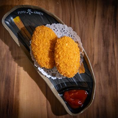 Panko-coated deep-fried mashed potato cakes.