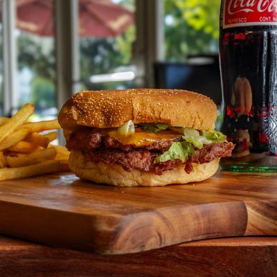 The Bacon Cheeseburger with fries and a bottle of soda.