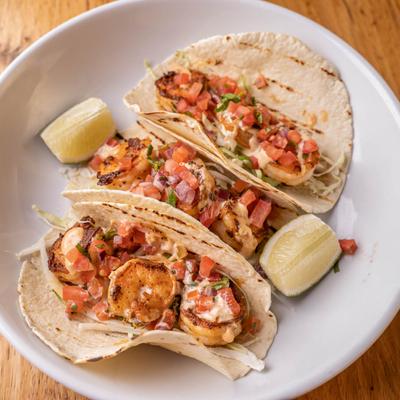 Shrimp tacos, with cabbage, pico, jack cheddar mix, and jalapeno crema.