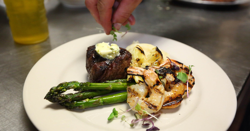 Grilled shrimp and small steak filet with frilled cauliflower and asparagus