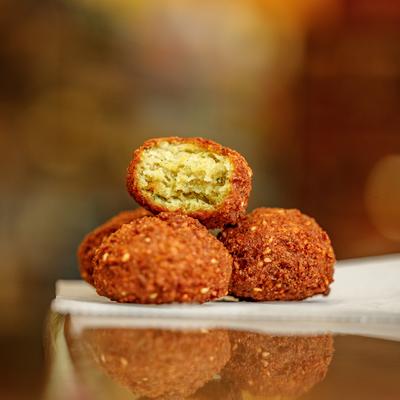 Falafel balls, one cut in half.