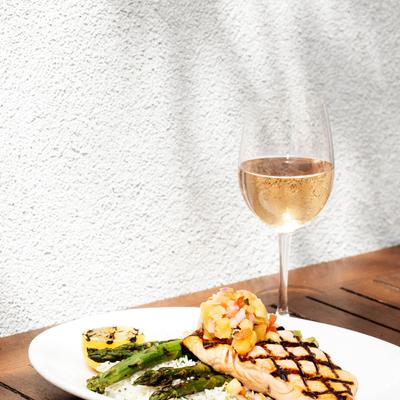 Grilled salmon, with pineapple salsa, rice, asparagus, and white wine.