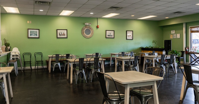 Diner area, tables, chairs, green wall behind