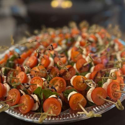 Tray of caprese skewers with tomatoes and mozzarella.