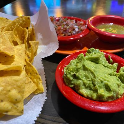 Close-up of guacamole with tortilla chips.