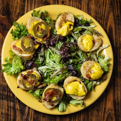 Fried Deviled Eggs served on a bed of greens.