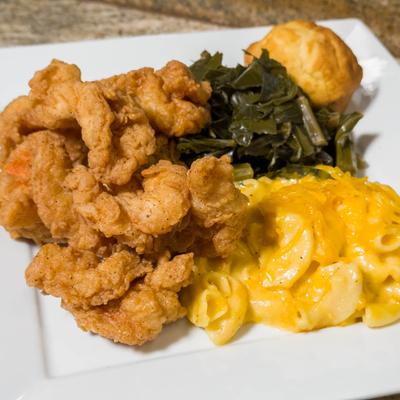 Fried shrimp with collards, mac and cheese, and cornbread muffin.