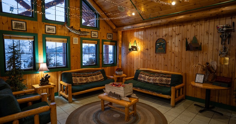 Cozy, rustic and warm cabin-style interior space with wooden sofas