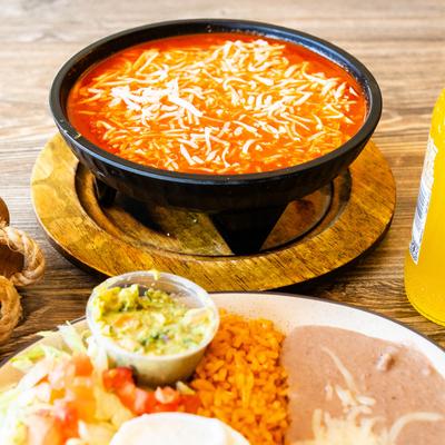 Molcajete Volcano served with rice, beans and salad.