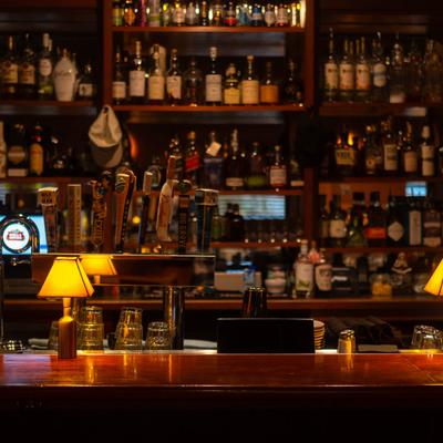 Beer taps and various liquor bottles on the shelf.