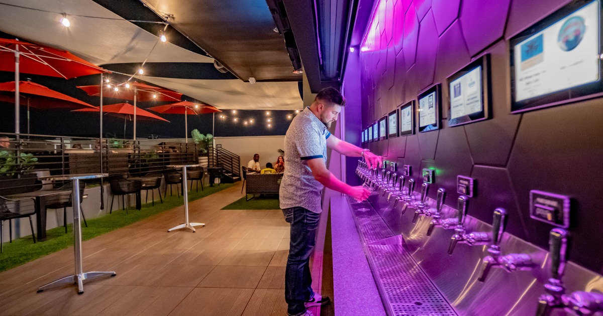 Man pouring drink on patio