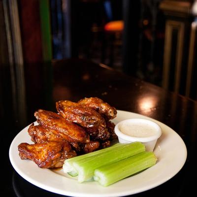 Wings paired with celery and a creamy dipping sauce.