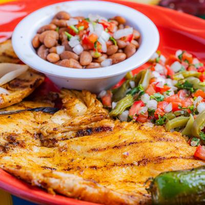 Grilled Chicken Breast served with whole beans, cactus salad and grilled green onions.