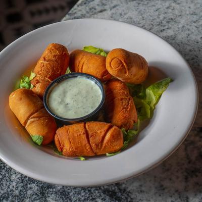 Spears of dough stuffed with queso blanco.