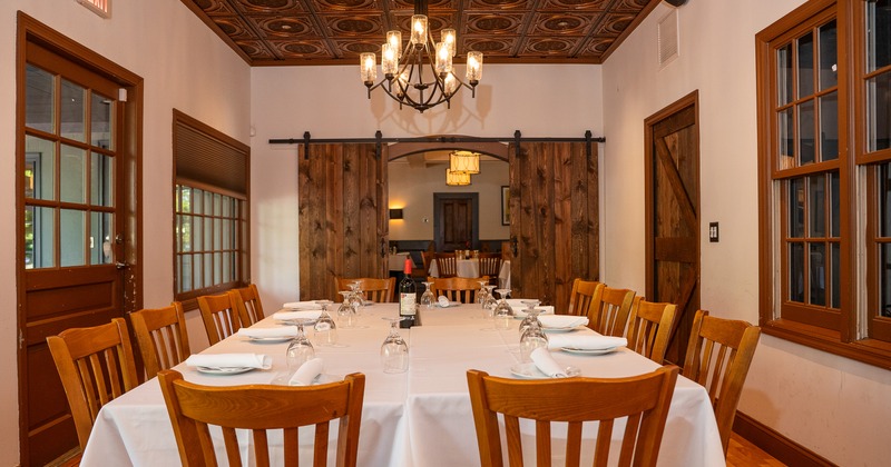 Elegant private dining room with a large dining table set for guests