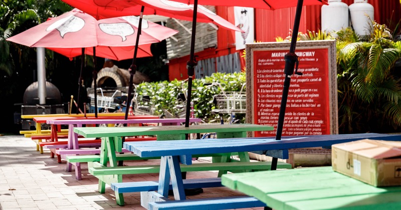 Exterior, tables with parasols and benches