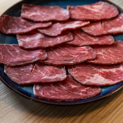 Sliced meat on a plate, closeup.