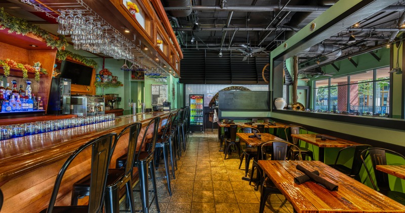 Interior, seating area with a bar on the left