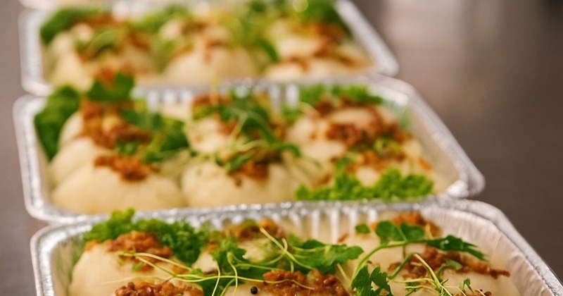 Grilled meat, salad, pasta and dip on the side