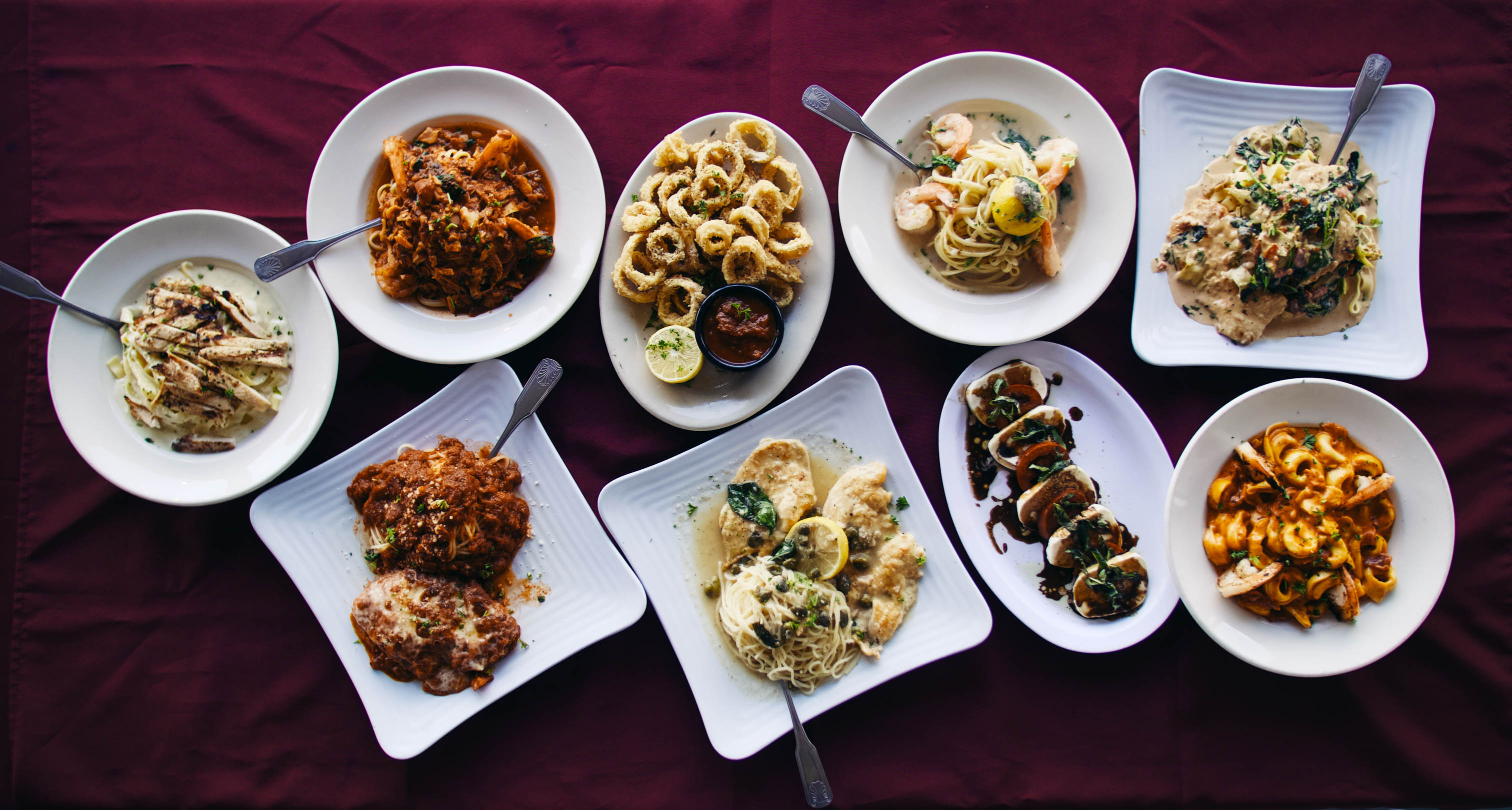 Assorted Italian dishes arranged across a dining table
