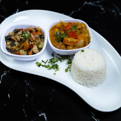 Chickpeas curry with side of rice and vegetables.