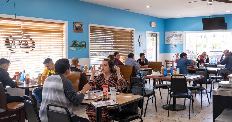 Interior, restaurant full of guests