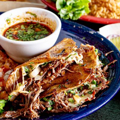 Birria tacos served with beef broth