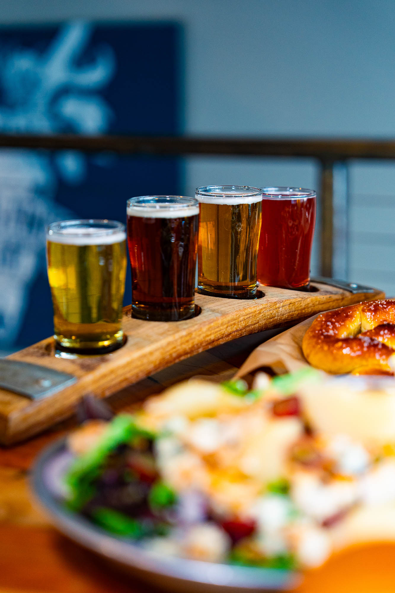 A beer flight on a table with food