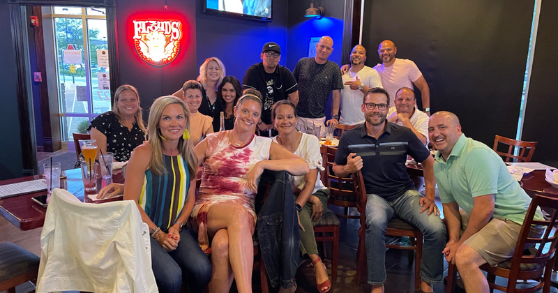 Interior, seated staff members and guests posing for the photo