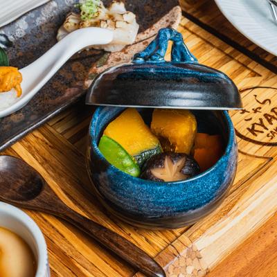 Traditional Japanese simmered vegetable dish served in a small pot.