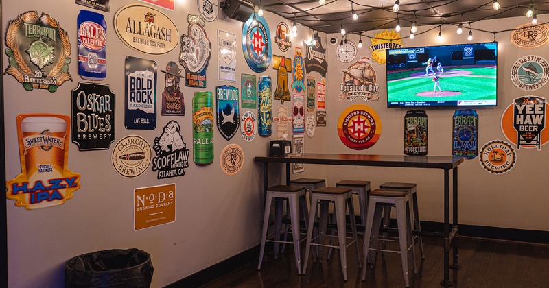 Interior, seating area, beer sticker decoration and TV on the walls