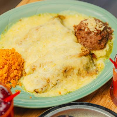 Carne asada covered in melted cheese.