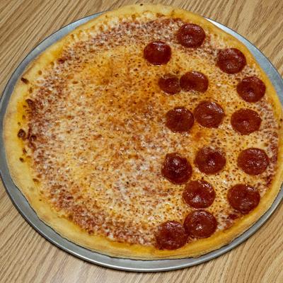 Half and half cheese and pepperoni pizza served on a metal tray.