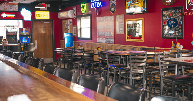 Interior, view of guest tables and seats from the bar counter