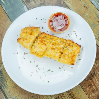 Cheesy crab bread cut into pieces with a dipping sauce.